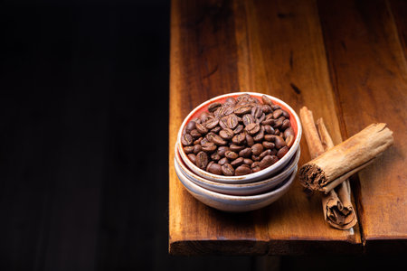 Premium Colombian coffee beans and cinnamon on wooden boardの写真素材