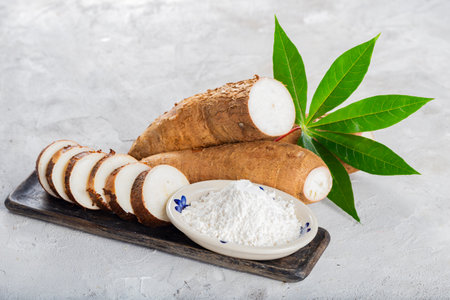 pile of cassava root and cassava flour on a gray and white textured background (Manihot esculenta)の写真素材