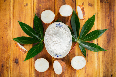 pile of cassava, cassava and cassava flour on a background of rustic wood (Manihot esculenta)の写真素材