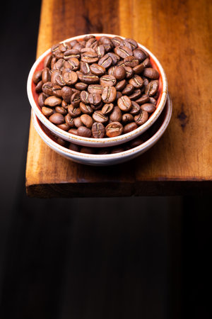 Premium Colombian Coffee Beans on Wooden Plankの写真素材