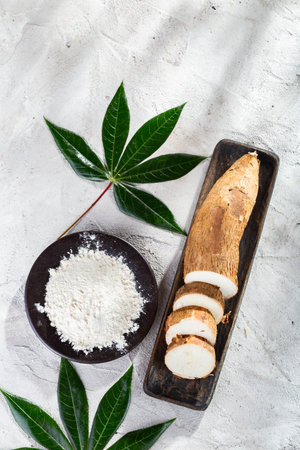 pile of cassava root and cassava flour on a gray and white textured background (Manihot esculenta)の写真素材