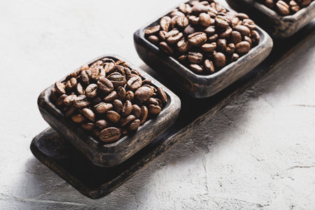 Coffee beans roasted in cup on light background, coffee from Colombiaの写真素材