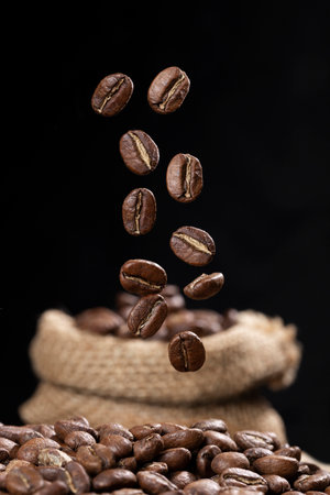 Roasted coffee beans from Colombia suspended in the air, Arabica variety.の写真素材