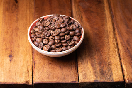 Premium Colombian Coffee Beans on Wooden Plankの写真素材