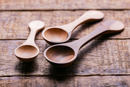 Three wooden measuring spoons on old table, close-upの写真素材