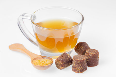 Piloncillo, ground piloncillo and piloncillo tea isolated on white backgroundの写真素材