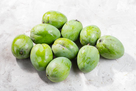 Pile of green mango, on a light surface