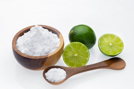 Baking soda in wooden container and lime, isolated on whiteの写真素材