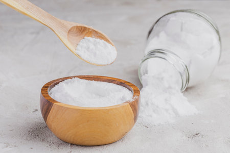 Baking soda in wooden container on rustic surfaceの写真素材