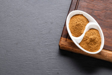 In the image you can see cinnamon powder on a wooden surfaceの写真素材