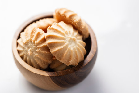 In the image you see a pile of delicious shortbread cookies, close up view, on a slate background