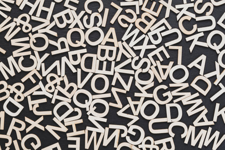 You can see in the image wooden letters on a blackboard background, arranged randomly