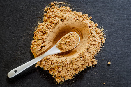 Medicinal maca powder on a gray slate surfaceの写真素材