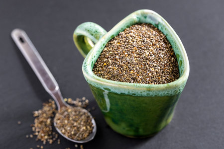 A pile of quinoa grains is seen in the image, in a ceramic containerの写真素材