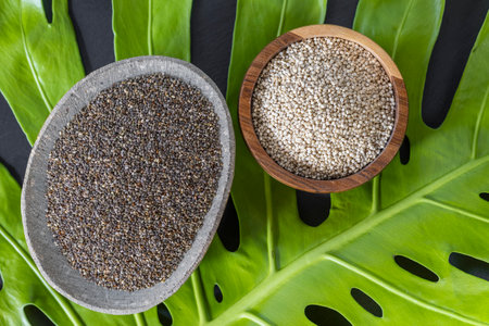 Chia and quinoa grains, in stone and wooden containers, top viewの写真素材