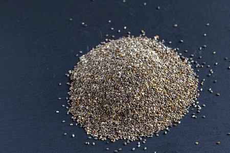 Pile of chia seeds on a chalkboard background, top viewの写真素材