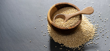 A pile of quinoa grains is seen in the image, in a wooden containerの写真素材