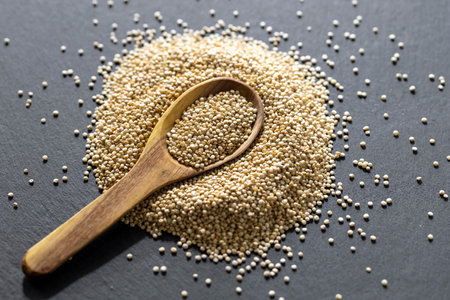 A pile of quinoa grains is seen in the image, in a wooden containerの写真素材
