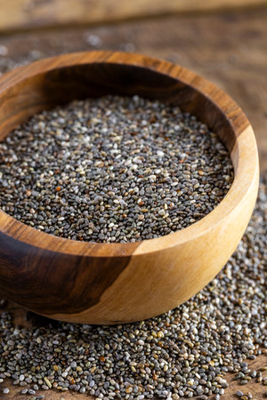 Pile of chia beans in a wooden container, close-up imageの写真素材