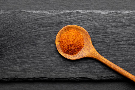 Colorful Spices on Wooden Spoons â Curry, Turmeric, and Paprika on Dark Slate Backgroundの写真素材