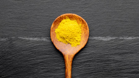 Colorful Spices on Wooden Spoons â Curry, Turmeric, and Paprika on Dark Slate Backgroundの写真素材