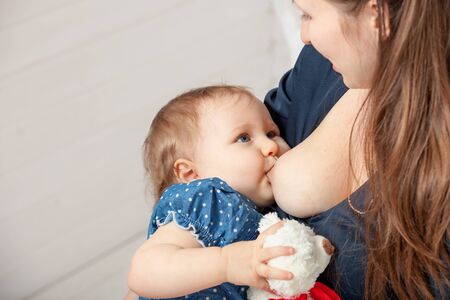 Mom breast feeding baby girl