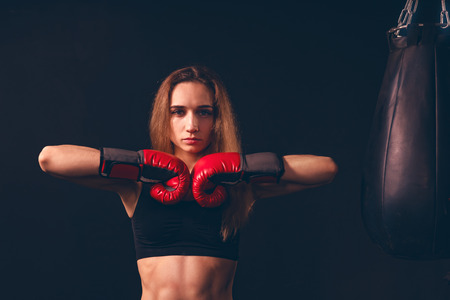 the boxer woman closed her fists in a gesture of readiness for battle. the confident strut of a...