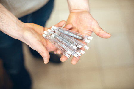 spoiled burnt-out halogen bulbs in handの写真素材