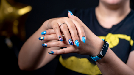 lot of color gloss manicure hand has different blotches in a light backgroundの写真素材
