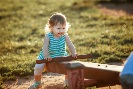 dangerous swings of the game for his age. fear of falling off the swing. danger on the children's Playground. a small child is afraid to fall. homemade dangerous swing.の写真素材
