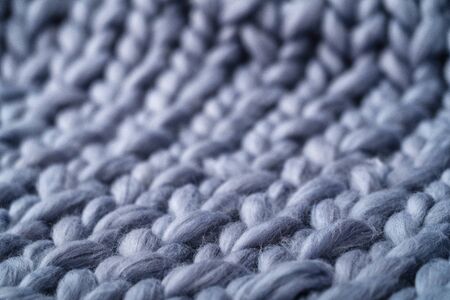 Merino wool handmade knitted large blanket, super chunky yarn, trendy concept. Close-up of knitted...