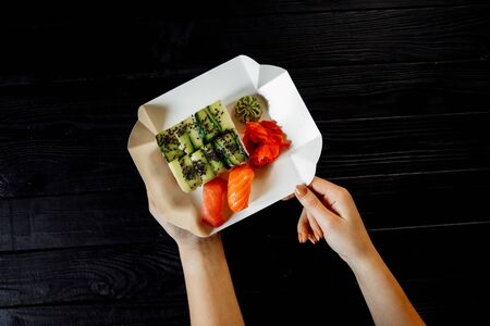 Asian cuisine, roles with fish, on a black background.の写真素材