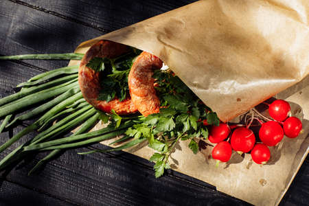 Sausage with bread and spices on a old wooden table. Dry-cured sausage with thyme, onion, garlic and...