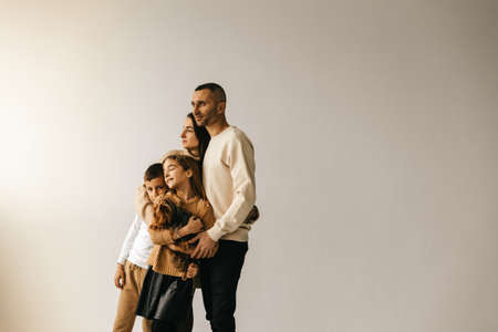 happy family posing on white background, loving parents, boy and girl. High quality photoの写真素材