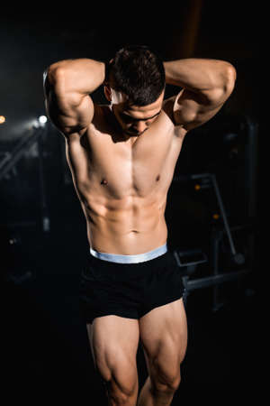 Muscular athlete shows off his biceps, torso, triceps, chest muscles. High quality photoの写真素材