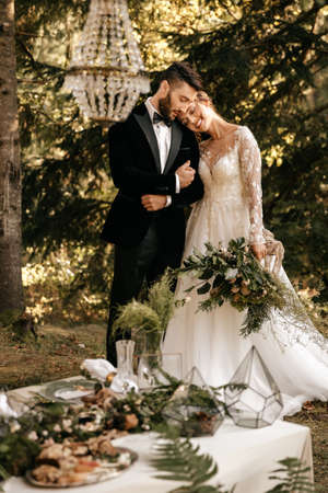 Newlyweds hug in the forest, forest wedding, a holiday in nature. High quality photoの写真素材