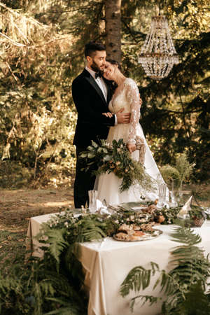Newlyweds hug in the forest, forest wedding, a holiday in nature. High quality photoの写真素材