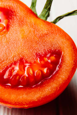 Fresh bright red tomato close-up cut, half tomato, on white background, isolated. High quality photo