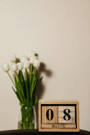 Wooden calendar 8 march, bouquet of white fresh tulips. High quality photoの写真素材