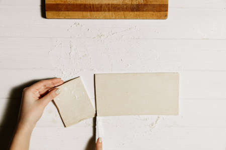 Dough for sweets, baking at home, making dough on a white table.の写真素材