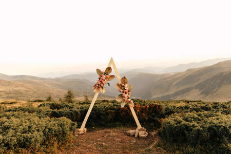 Ceremony, arch, wedding arch, wedding, wedding moment, decorations, decor, wedding decorations, flowers, outdoor ceremony in the open air, bouquets of flowers. High quality photoの写真素材