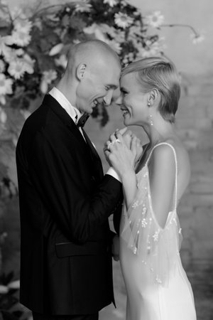 Young beautiful happy couple hugging and smiling near the arch. Black and white photoの写真素材