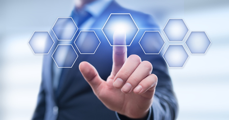 Businessman pressing button on virtual screen. Man pointing on futuristic interface. Innovation technology internet and business concept. Space for text. Abstract background.の写真素材