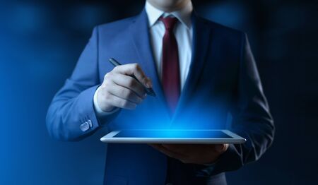 Businessman holding digital tablet. Man using gadget in officeの写真素材