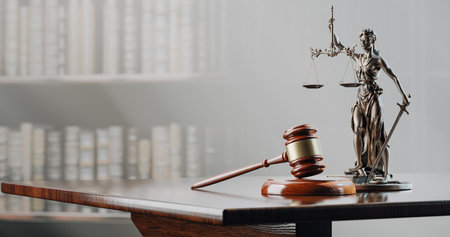 Legal Concept: Themis is the goddess of justice and the judges gavel hammer as a symbol of law and order on the background of booksの写真素材