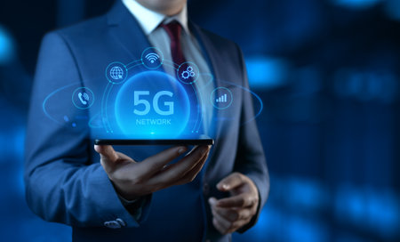 Businessman Holding Smartphone with 5G Network Icons on Screen. Business and Technology conceptの写真素材