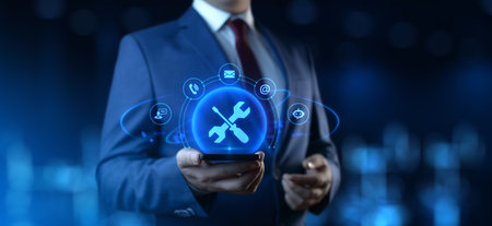 Businessman Holding smartphone with Technical Support Icons on Screen. Customer Service and Support conceptの写真素材