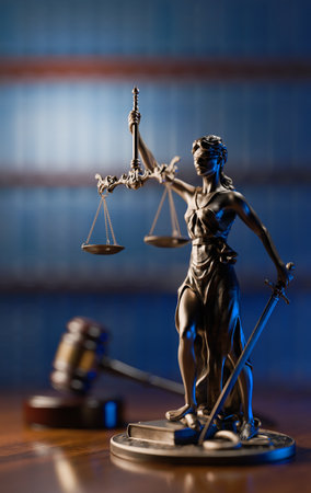Legal Concept: Themis is the goddess of justice and the judges gavel hammer as a symbol of law and order on the background of booksの写真素材
