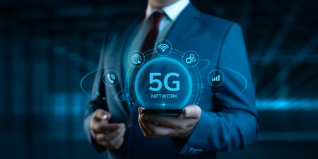 Businessman Holding Smartphone with 5G Network Icons on Screen. Business and Technology conceptの写真素材
