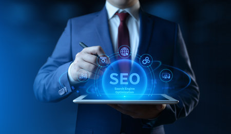 Businessman holding tablet with Search Engine Optimization SEO icons on screen - Digital Marketing Conceptの写真素材